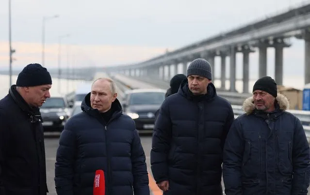 Russian President Vladimir Putin, flanked by Deputy Prime Minister Marat Khusnullin (L), visits the Kerch Strait Bridge, also known as the Crimean Bridge on December 5, 2022. The bridge, that links Russia's mainland with the Crimean Peninsula, was damaged by an attack on October 8, 2022. (Photo by Mikhail Metzel/Sputnik via AFP Photo)