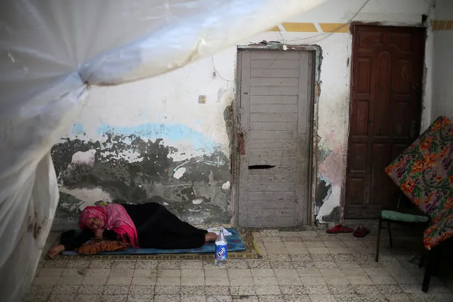 A Palestinian woman rests at her house in Khan Younis refugee camp in the southern Gaza Strip January 3, 2018. (Photo by Ibraheem Abu Mustafa/Reuters)