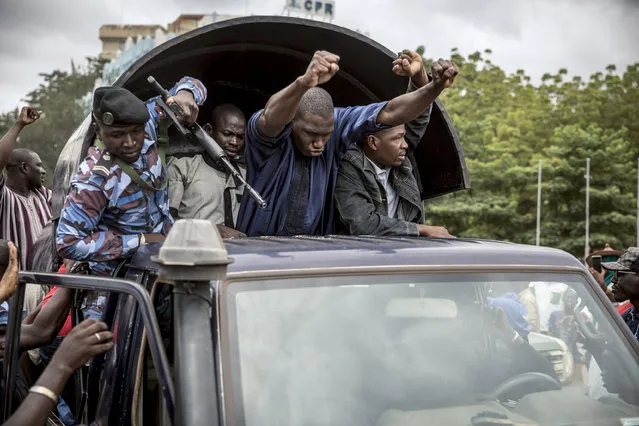 Security forces and others in celebration drive through the streets of the capital Bamako, Mali, Wednesday, August 19, 2020, a day after armed soldiers fired into the air outside President Ibrahim Boubacar Keita's home and took him into their custody. African and Western leaders condemned on Wednesday the junta that forced Mali's president from power, warning the coup was a deep setback for the West African nation that could threaten the battle against Islamic extremism. (Photo by AP Photo/Stringer)