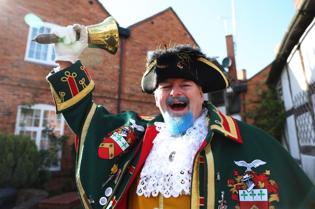 John Griffiths of Sleaford poses for a photo after becoming champion in the Heart of England Town Criers Championship on March 30, 2024 in Alcester, England. From Medieval times, the town crier served as a primary means of news communication with the townsfolk, disseminating royal proclamations, adverts, and newsworthy events. Although the profession was largely phased out in the early 20th Century with the growth of newspapers, town crier competitions are now held for ceremonies or to add color to special events. The Ancient & Honourable Guild of Town Criers (AHGTC), founded in 1978 at Hastings, works to standardise competitions and keep the profession alive. (Photo by Cameron Smith/Getty Images)