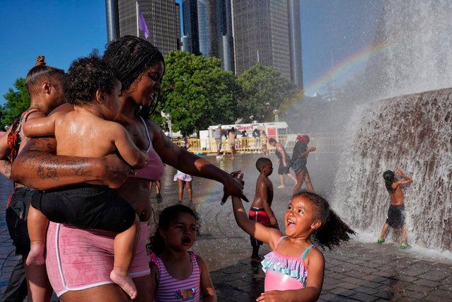 Kiara Daniels holds her son Kayson while twirling her daughter, Kehlani, at the Dodge Fountain in downtown Detroit’s Hart Plaza on Monday, June 23, 2025. They were waiting for the start of a fireworks show. (Photo by Ryan Garza/USA Today Network/Imagn Images)