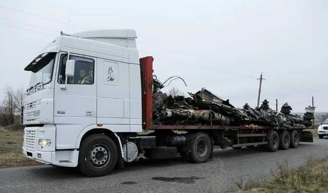 A truck transports wreckage of the Malaysia Airlines Boeing 777 plane (flight MH17) at the site of the plane crash near the settlement of Grabovo in the Donetsk region November 16, 2014. (Photo by Antonio Bronic/Reuters)