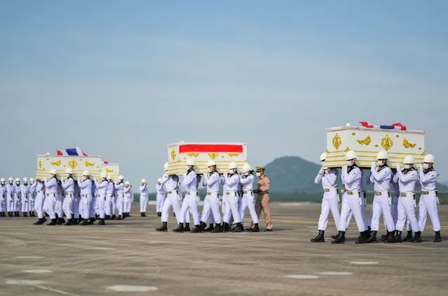A handout photo made available by the Royal Thai Navy shows Thai navy personnel carrying the coffins of Royal Thai Navy Sukhothai crew members, who died after the Sukhothai sank in rough seas in the Gulf of Thailand, upon the arrival at the military base for religious ceremonies, at Sattahip in Chonburi province, Thailand, 26 December 2022. The Royal Thai Navy ship HTMS Sukhothai, carrying over 100 crew, capsized and sank in rough seas in the Gulf of Thailand on late 18 December night. Authorities rescued most of the crew and a search for 11 missing sailors continued, with 18 bodies recovered currently. (Photo by The Royal Thai Navy/EPA/EFE)
