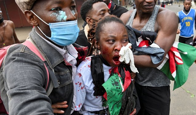 People assist an injured person during demonstrations in Nairobi, Kenya on June 25, 2025. (Photo by John Muchucha/Reuters)