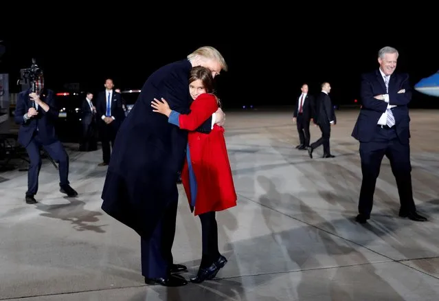 U.S. President Donald Trump hugs his granddaughter, Arabella Kushner, following a campaign rally at Pittsburgh International Airport in Pittsburgh, Pennsylvania, U.S., September 22, 2020. (Photo by Tom Brenner/Reuters)