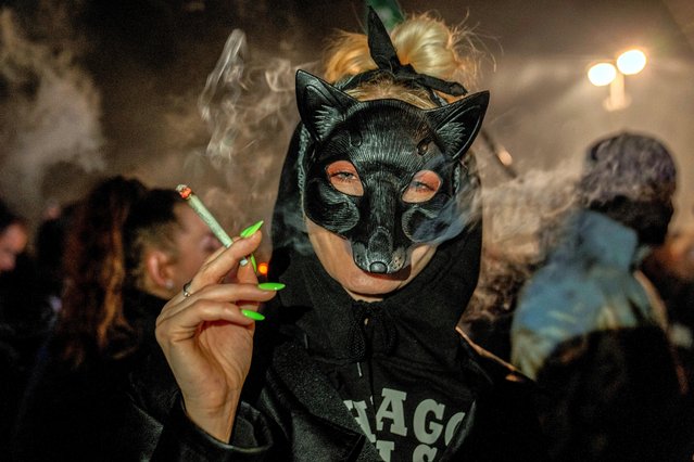 People smoke marijuana in front of the Brandenburg Gate during the 'Smoke-In' event in Berlin, Germany, Monday, April 1, 2024. Starting 1 April, Germany has legalised cannabis for personal use. As per the new law, Adults aged 18 and over will be allowed to carry up to 25 grams of cannabis for their own consumption. (Photo by Ebrahim Noroozi/AP Photo)