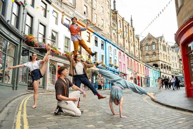 Members of the cast of circus company Flip Fabrique perform extracts from their show during a photocall in Victoria Street ahead of the start of the Edinburgh Fringe on July 31, 2025 in Edinburgh, Scotland. (Photo by Roberto Ricciuti/Getty Images)