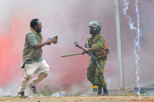A riot police officer prepares to accost a protestor after lobbing teargas canister to disperse the protestors during a demonstration in Nairobi, Kenya on June 25, 2025. (Photo by John Muchucha/Reuters)
