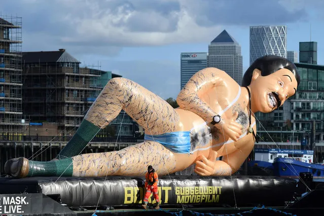 An inflatable in the form of Borat, UK comedian Sacha Baron Cohen’s fictional Kazakh reporter floats down the River Thames in London to promote the release of the sequel, Borat Subsequent Moviefilm on October 22, 2020. (Photo by Justin Tallis/AFP Photo)
