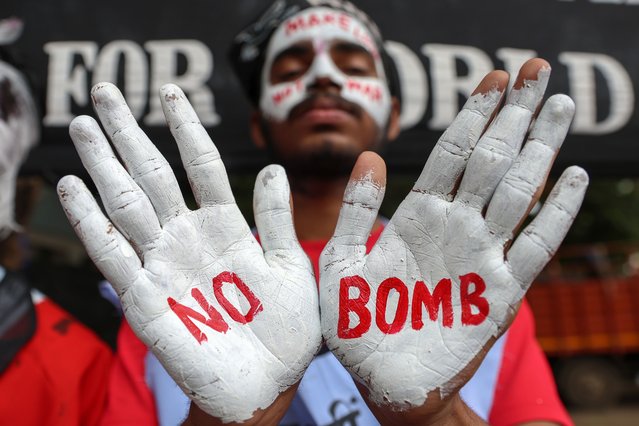 An Indian student with peace messages written on his face and hands takes part in a “Hiroshima Day” peace rally in Mumbai, India, 06 August 2025. Students and social activists gathered in Mumbai to mark the 80th anniversary of the nuclear bombing in Hiroshima. (Photo by Divyakant Solanki/EPA)