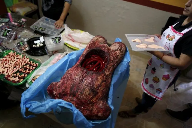 A bloody, open torso with guts made of gummy candy and red jelly is pictured at the Zombie Gourmet homemade candy manufacturer on the outskirts of Mexico City October 30, 2015. (Photo by Carlos Jasso/Reuters)