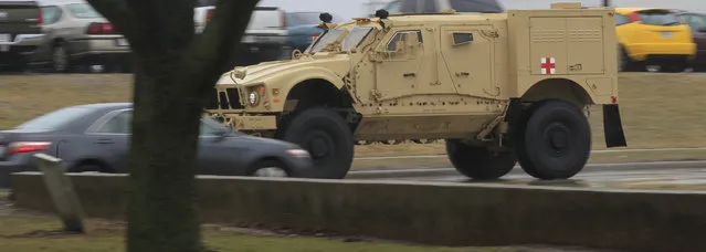 A view motorists have grown accustomed seeing, a military truck made by Oshkosh Corp. is taken for a test drive Thursday, April 11, 2013 in Oshkosh, Wis. Faced with deep cuts in U.S. military spending, and the end of the wars in Iraq and Afghanistan, Oshkosh Corp. is laying off 900 employees in its defense division based in Oshkosh. Approximately 700 hourly workers at the state's largest manufacturer will lose their jobs in mid-June, followed by approximately 200 salaried employees through July. (Photo by Mark Hoffman via The Journal Sentinel)