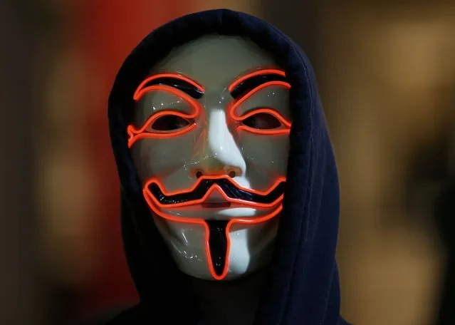 A supporter of the activist group Anonymous wears a mask during a protest in London, Britain November 5, 2015. (Photo by Peter Nicholls/Reuters)