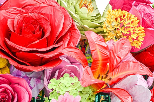 Workers trim and decorate the floral displays at Tiananmen Square to make preparations for the National Day on September 19, 2025 in Beijing, China. (Photo by VCG/VCG via Getty Images)