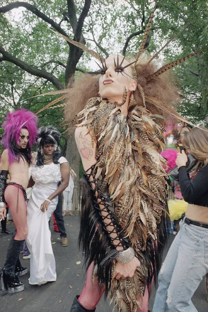 A reveler dresses in drag and poses for the camera during the annual Wigstock 92 celebration at New York's Tompkins Square Park, Monday, September 7, 1992, New York. The reveler who would only identify himself as “Guy”, was one of thousands who participated in this year's event which was also visited by Democratic Senate hopeful Liz Holtzman who seeking votes. (Photo by Bob Strong/AP Photo)