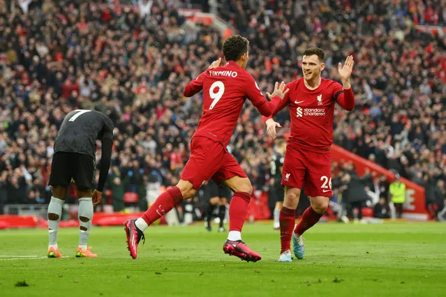 Roberto Firmino of Liverpool celebrates after scoring the team's second goal with teammate Andrew Robertson during the Premier League match between Liverpool FC and Arsenal FC at Anfield on April 09, 2023 in Liverpool, England. (Photo by Shaun Botterill/Getty Images)