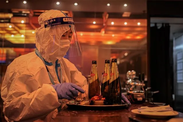 A worker in a hazmat suits works in a bar at a hotel restaurant, which is part of the closed-loop Winter Olympics Accommodation Allocation Agreement (AAA) on February 10, 2022 in Beijing, China. As the Beijing 2022 Winter Olympics gets underway in earnest, interest remains high in seeing how the country will run one of the world's premier sporting events in the midst of a global pandemic. To try and maintain China's zero-covid approach, the games will take place in a closed bubble with strict daily testing requirements. (Photo by Annice Lyn/Getty Images)