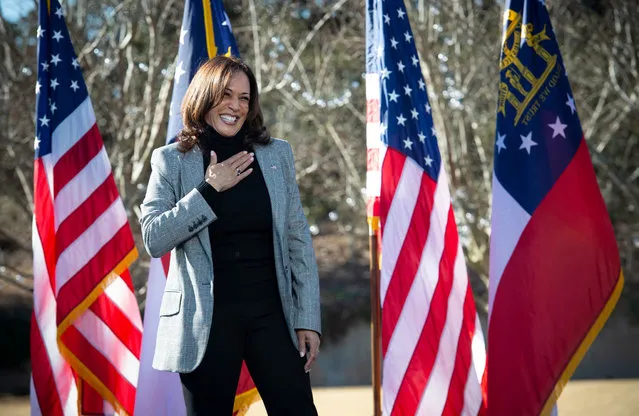 The vice president-elect, Kamala Harris, reacts to loud cheers from the crowd in Columbus on December 21, 2020 as she campaigns for Democratic Senate candidates at a drive-in rally. (Photo by Robin Rayne/ZUMA Wire/Rex Features/Shutterstock)