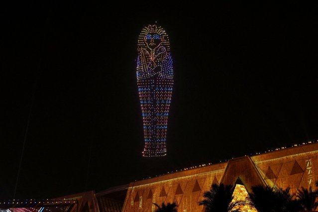 A drone light show depicts ancient pharaoh king Tutankhamen's sarcophagus during the opening ceremony of the Grand Egyptian Museum (GEM), near the Giza pyramid complex, in Giza, Egypt, on November 1, 2025. (Photo by Mohamed Abd El Ghany/Reuters)