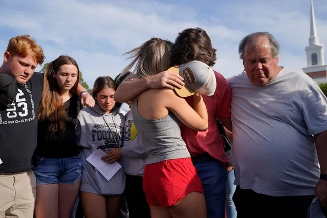 Community members embrace each other during a vigil the day after a shooting during a teenager's birthday party at Mahogany Masterpiece Dance Studio in Dadeville, Alabama, U.S., April 16, 2023. (Photo by Cheney Orr/Reuters)