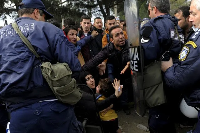 Greek policemen push back Syrian, Iraqi and Afghan refugees who tried to force their way through the Greek-Macedonian borders near the village of Idomeni, Greece November 22, 2015. (Photo by Alexandros Avramidis/Reuters)