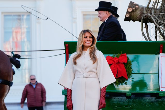 First lady Melania Trump receives the official 2025 White House Christmas Tree, a white fir from Korson's Tree Farms in Michigan, on the North Portico of the White House, Monday, November 24, 2025, in Washington. (Photo by Julia Demaree Nikhinson/AP Photo)