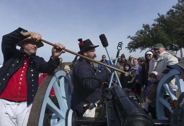 Kameron Rome (L) and Mike Robertson of Strathroy, Ontario, Canada, demonstrate a cannon they fired during a commemoration of the Battle of New Orleans in the War of 1812, marking its bicentennial in Chalmette, Louisiana January 10, 2015. (Photo by Lee Celano/Reuters)