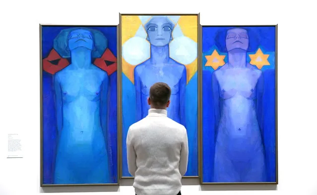 A gallery worker views the work Evolution by Dutch painter Piet Mondrian during the press preview for “Hilma Af Klint and Piet Mondrian: Forms of Life” at the Tate Modern in London, Britain, 18 April 2023. (Photo by Neil Hall/EPA)