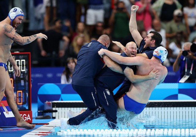 Serbia coach Uros Stevanovic and team Serbia celebrate after winning the men's water polo gold medal match between Serbia and Croatia during the Paris 2024 Olympic Games at the Paris La Defense Arena in Paris on August 11, 2024. (Photo by Ueslei Marcelino/Reuters)