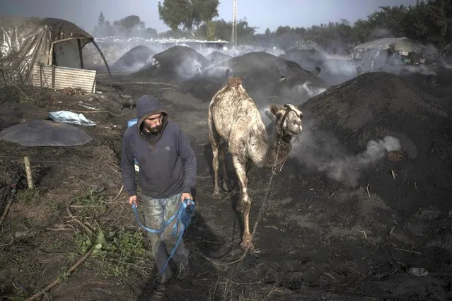 Palestinians work at a traditional charcoal production site in the town of Jabaliya, Northern Gaza Strip, Thursday, January 7, 2021.(Photo by Khalil Hamra/AP Photo)