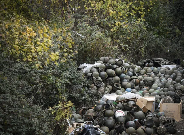 A pile of Armenian army helmets lie on the ground close to an Armenian Army barracks, where soldiers say there is no indoors storage space left, on November 15, 2020, outside of the zone of the the region's administrative centre of  Stepanakert, where a Russian peacekeeping contingent deployed this week. Azerbaijan said on November 15, 2020, it had agreed to extend a deadline for Armenia to withdraw from a disputed district as part of a peace accord that ended six weeks of fierce fighting over the Nagorno-Karabakh region. Armenia lost around 2300 dead during the military conflict over this breakaway region. (Photo by Alexander Nemenov/AFP Photo)