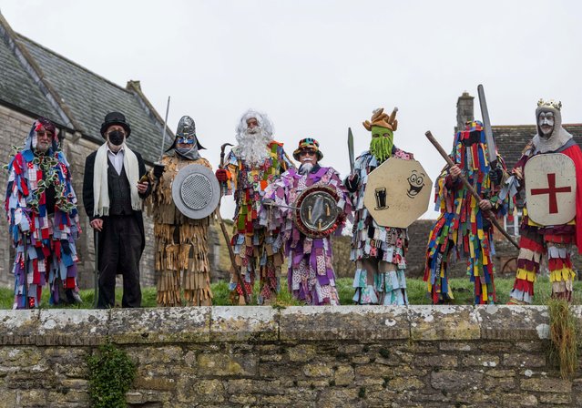The Purbeck Mummers – an ancient Dorset folk tradition – perform at the historic village of Corfe Castle, UK on December 27, 2024. The work featured the hero King George battling against fools and knights. The Mummers’ identities are concealed or “kept mum”. (Photo by BNPS)