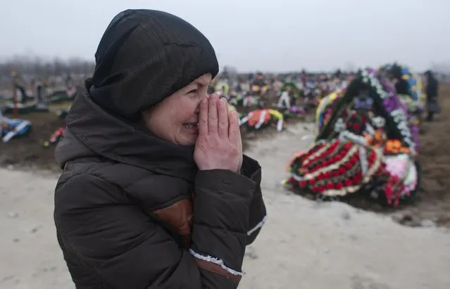 A relative of a victim of recent shelling reacts at a cemetery in Mariupol, a city on the Sea of Azov, January 27, 2015. (Photo by Maksim Levin/Reuters)