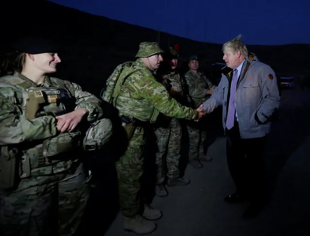 Britain's Foreign Secretary Boris Johnson (R) shakes hands with British soldiers during his visits from Camp Qargha in Kabul, Afghanistan November 26, 2016. (Photo by Mohammad Ismail/Reuters)