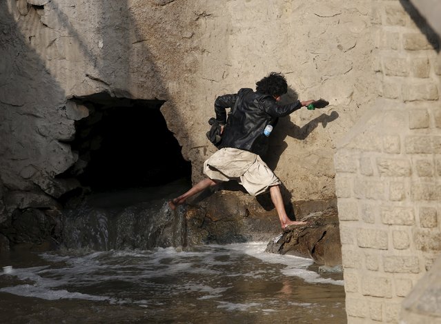A man runs away during a police round up of suspected drug addicts in Kabul, Afghanistan December 27, 2015. Afghan officials have opened a new drug treatment centre in an abandoned NATO military base in Kabul, in the latest attempt to stamp out the country's massive problem of drug abuse. Camp Phoenix, a former training camp on the edges of Kabul set up by the U.S. army in 2003, will take in around 1,000 homeless drug addicts who will receive food, medical attention and treatment, said Public Health Minister Ferozuddin Feroz. (Photo by Ahmad Masood/Reuters)