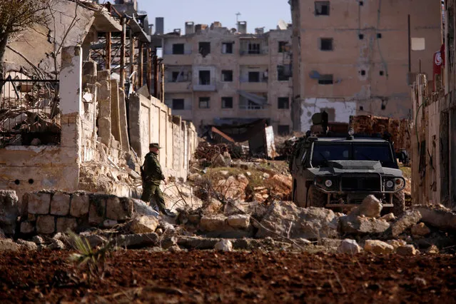 A Russian soldier walks to a military vehicle in goverment controlled Hanono housing district in Aleppo, Syria December 4, 2016. (Photo by Omar Sanadiki/Reuters)