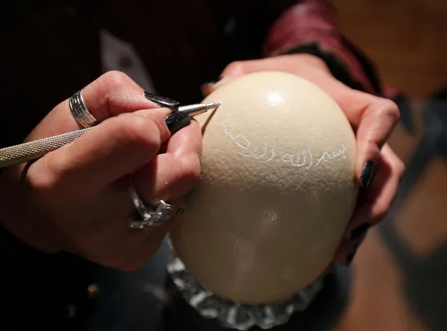 A businesswoman Maha Shalaby sculpts “in the name of Allah the most merciful” onto an ostrich egg in Cairo, Egypt November 27, 2016. Picture taken November 27, 2016. (Photo by Mohamed Abd El Ghany/Reuters)
