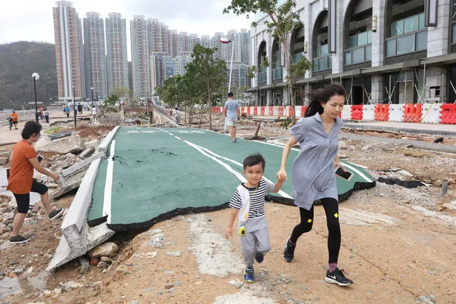 People walk through a damaged path after Super Typhoon Mangkhut hit Hong Kong, China on September 18, 2018. (Photo by Ken Tung/Reuters)