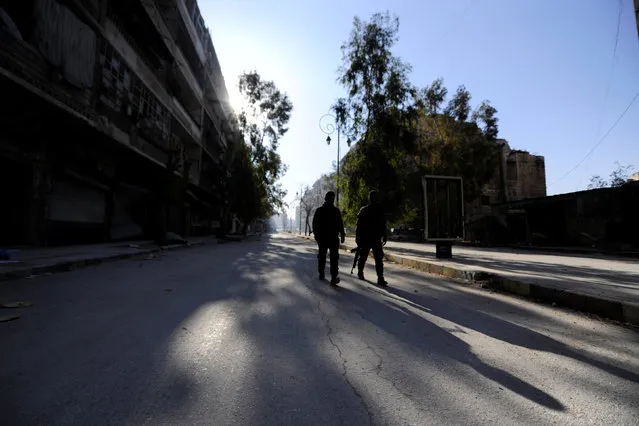 Forces loyal to Syria's President Bashar al-Assad walk along a street in a government held area of Aleppo, Syria December 9, 2016. (Photo by Omar Sanadiki/Reuters)