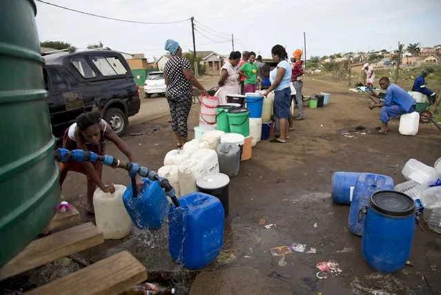 People queue to collect water from a tank after water to homes was cut off due to the drought in KwaMsane, northeast of Durban, South Africa January 20, 2016. (Photo by Rogan Ward/Reuters)