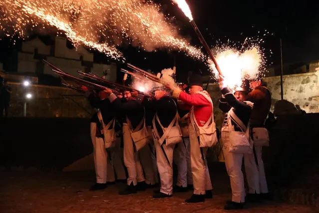 Extras fire their weapons during a historical recreation of the attack on the Fort of Graca in Elvas, Portugal, 05 June 2022, which intends to evoke the siege that took place in 1811 by the French army. (Photo by Nuno Veiga/EPA/EFE)