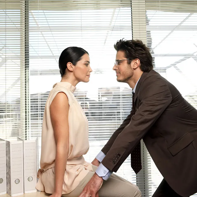 Couple facing each other in office. (Photo by Luc Beziat/Getty Images)