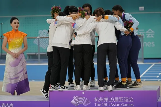 Gold medalists from team Taiwan, center, silver medalists South Korea, left, and bronze medalists India, right, celebrate on the podium during the awards ceremony of the women's Speed Skating 3000 meter Relay Race G1 at 19th Asian Games in Hangzhou, China, Monday, October 2, 2023. (Photo by Aijaz Rahi/AP Photo)