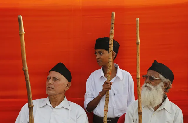 In this October 19, 2018, photo, members of the Rashtriya Swayamsevak Sangh (RSS), a hard-line Hindu group that created the ruling Bharatiya Janata Party as its political arm, attend Vijay Dashmi festival celebrations in Allahabad, India. Vijayadashami, also known as Dussehra, commemorates the victory of the Hindu god Rama over demon god Ravana. The festivity is marked with the burning of effigies of Ravana, signifying the victory of good over evil. (Photo by Rajesh Kumar Singh/AP Photo)
