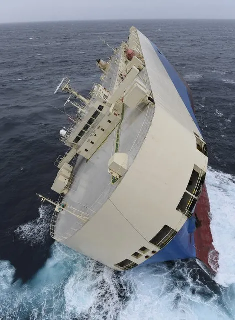 In this photo taken on Thursday, Jan. 28, 2016 and provided by the  Prefecture Maritime Atlantique on Friday, January 29, 2016, the cargo ship “Moderm Express” is pictured drifting off the coast of France. The cargo ship listing in the water is drifting empty off the coast of France, as maritime rescue workers wait for the seas to calm. (Photo by Loic Bernardin/ Prefecture Maritime Atlantique via AP Photo)