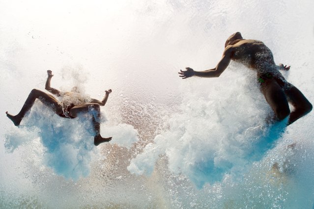 In a picture taken with an underwater camera Mexico's Ivan Garcia and German Sanchez enter the water as they compete in the men's 10-metre synchro platform preliminary diving event in the FINA World Championships at the Piscina Municipal de Montjuic in Barcelona on July 21, 2013. (Photo by Francois Xavier Marit/AFP Photo)