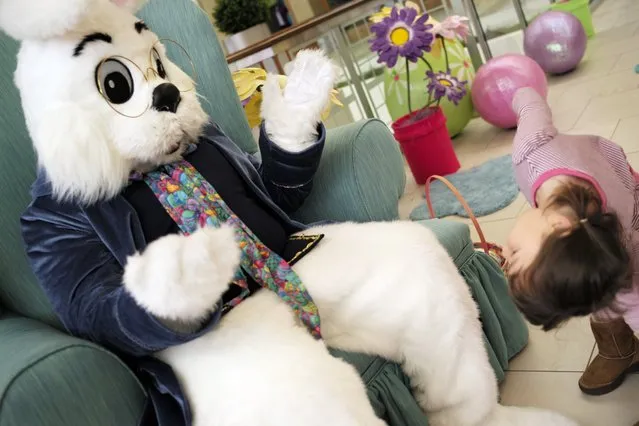 At Southdale Center in Edina, the Easter Bunny, a.k.a. Ryan Eide played peekaboo with Caroline Phan, 4, of Richfield who got a kick out of the meet and greet. (Photo by Richard Tsong-Taatarii/Star Tribune)