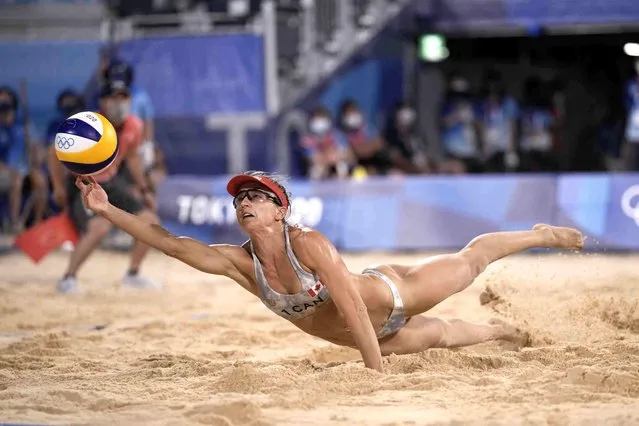 Heather Bansley, of Canada, dives for the ball during a women's beach volleyball match against Brazil at the 2020 Summer Olympics, Thursday, July 29, 2021, in Tokyo, Japan. (Photo by Felipe Dana/AP Photo)