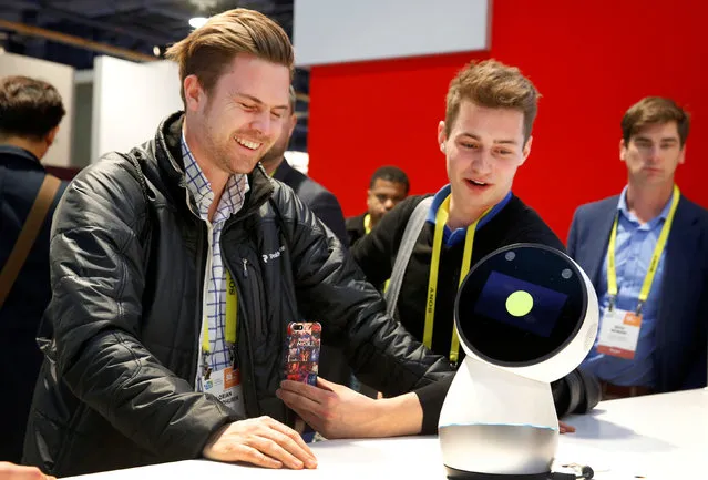 Florian Schmidhuber (L) and Lukas Reiber of Austria interact with Jibo, a social home robot, during the 2017 CES in Las Vegas, Nevada January 6, 2017. (Photo by Steve Marcus/Reuters)