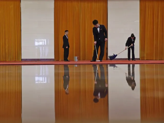 Workers clean carpets before a welcoming ceremony for Austrian President Heinz Fischer at the Great Hall of the People in Beijing, March 27, 2015. (Photo by Kim Kyung-Hoon/Reuters)